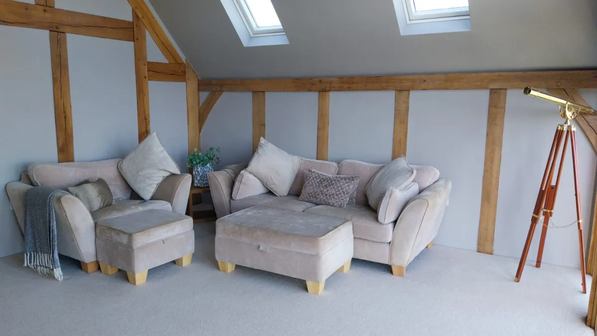 Vaulted oak-beamed living room with freshly painted grey walls