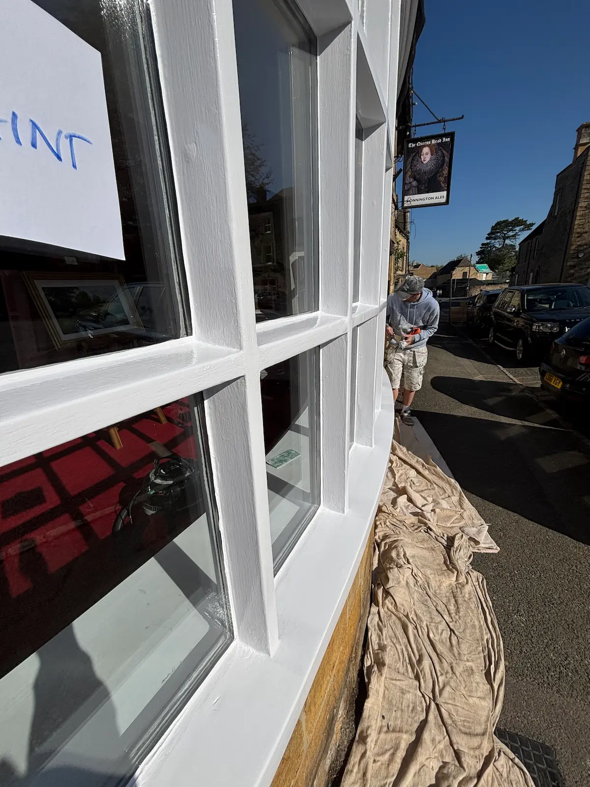 Newly painted exterior wooden window frames on a Cotswold gallery