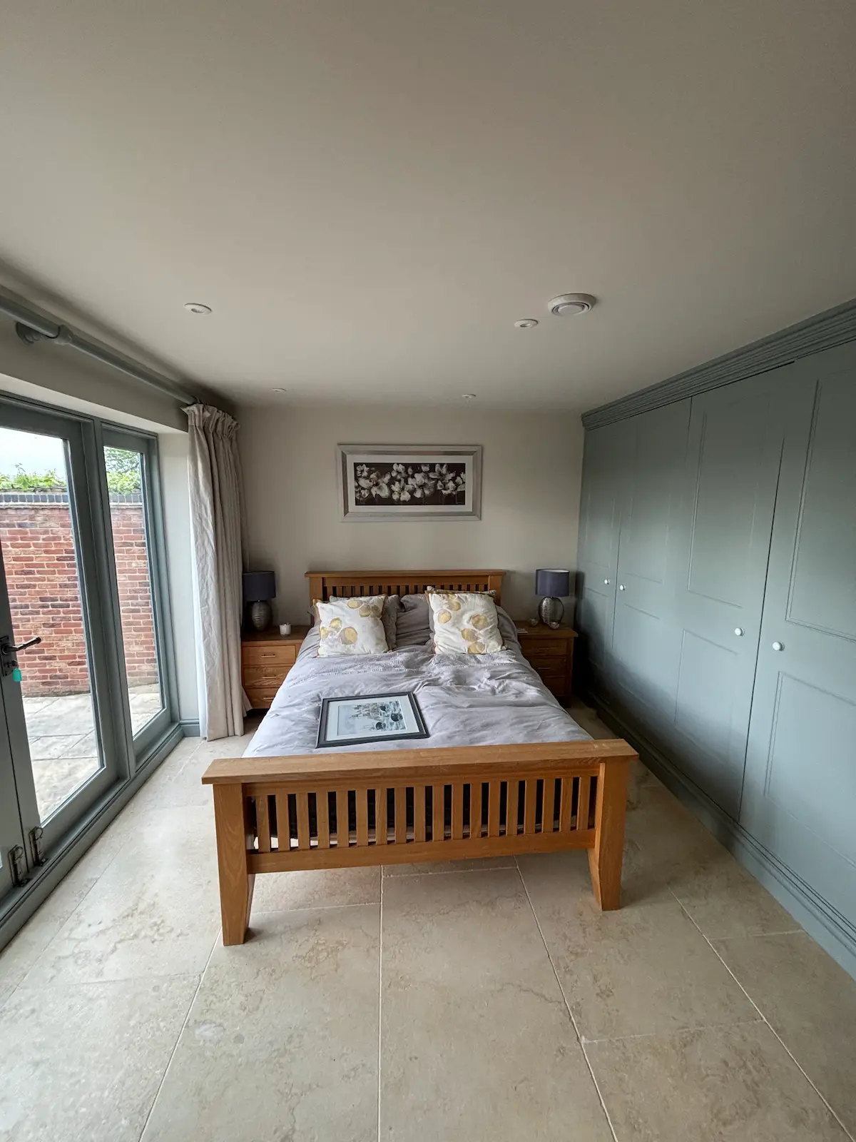 Bedroom with freshly painted walls and teal built-in wardrobe