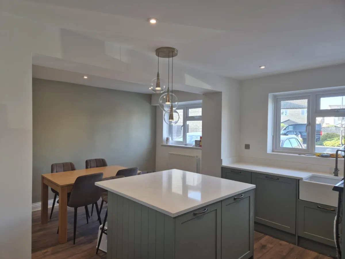 Sage green kitchen with island and freshly painted walls