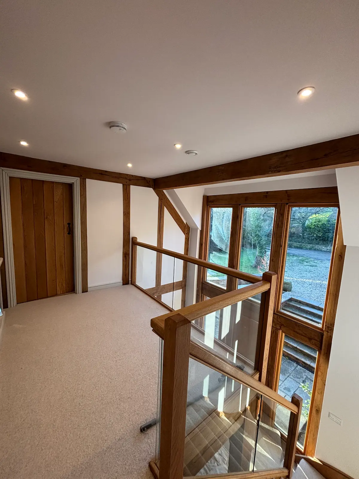 Freshly painted beamed upstairs landing in a barn conversion